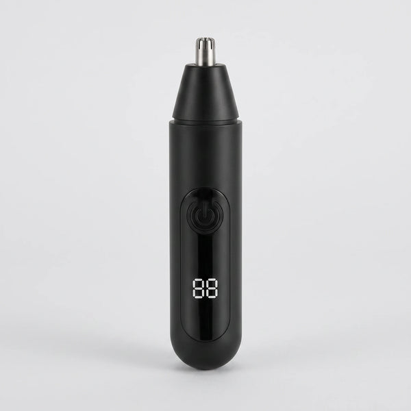 The trimmer standing alone on a plain grey surface